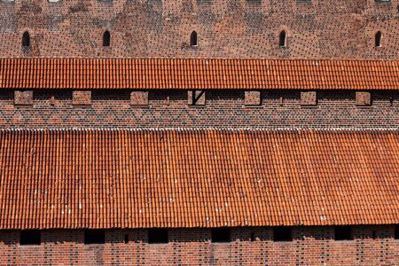 Malbork Castle fortification in Poland, covered battlement with tiled roof.