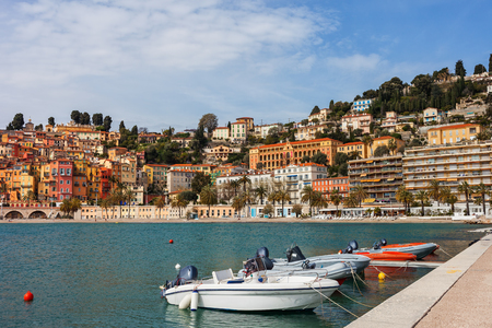 France, Cote d'Azur, Menton skyline and boats at bay waterfront, resort town on French Riviera at Mediterranean Seaの写真素材