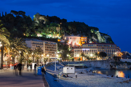 City of Nice by night in France, beach and promenade, view to Castle Hill, French Riviera (Cote d'Azur) picturesque coastline.の写真素材