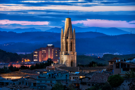 Illuminated bell tower of the Sant Feliu Basilica at dusk in city of Girona in Catalonia, Spain.の写真素材