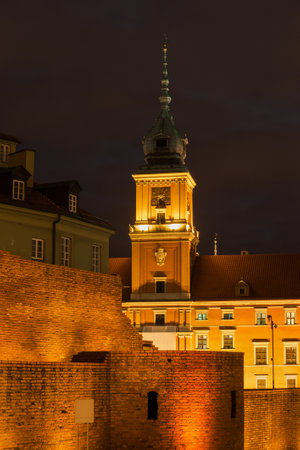 Royal castle and city wall illuminated at night in Old Town of Warsaw in Polandのeditorial素材