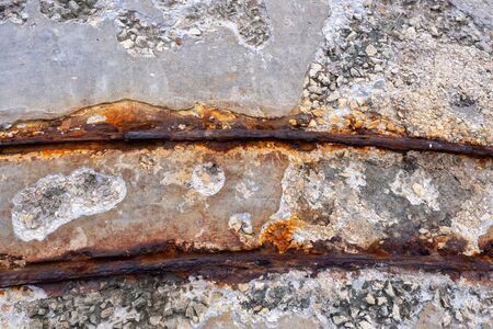 Narrow rusty railway track abstract background, corroded from salt water and abandoned rail transport structure at old sea waterfront.の写真素材