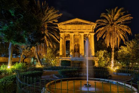 Lower Barrakka Gardens at night in Valletta, Malta, city garden with fountain and Monument to Sir Alexander Ball from 1810.の写真素材