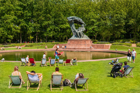 Warsaw, Poland - August 9, 2019: People relax on green lawn in front of the Chopin Monument in Royal Lazienki Parkのeditorial素材