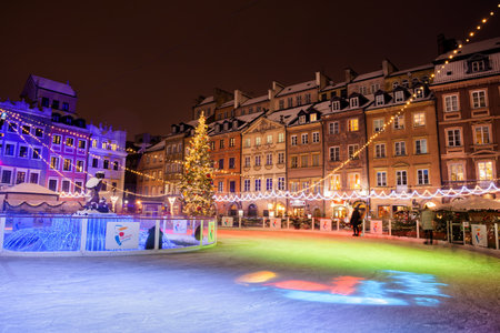Warsaw, Poland - January 1, 2019: Ice skating rink in Old Town Square in capital city at night during Christmas time.のeditorial素材