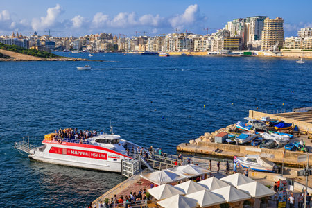 Valletta, Malta - Otctober 12, 2019: People entering and leaving VFS ferry boat between city of Valletta and Sliema town in Marsamxett Harbour in the Mediterranean Seaのeditorial素材