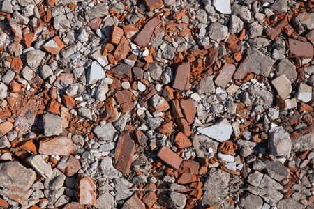 Rubble debris background or texture with pieces of bricks, broken tiles, stones and plaster left...
