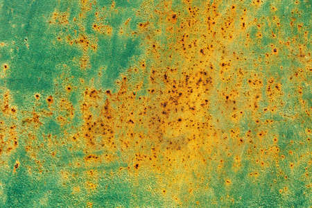 Iron plate metal background or texture, iron plate with visible corrosion, orange, yellow and aquamarineの写真素材