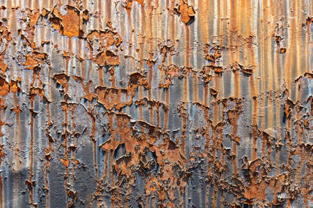 Rusty metal background or texture with peeling paint, iron plate from an old locomotive