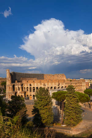 Colosseum at sunset in city of Rome, Italy, ancient Flavian Amphitheatre and Gladiators stadium, view from top of Palatine Hill.の写真素材