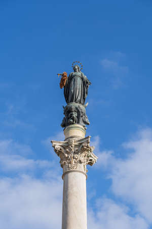 Column of the Immaculate Conception (Italian: La Colonna della Immacolata) at Piazza Mignanelli in Rome, Italy, 19th century monument to Virgin Mary carrying a wreath of flowers on ancient Corinthian column.の写真素材