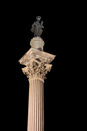 Column of Peace (Colonna della Pace) at night with statue of Virgin Mary with Child by Guillaume Berthelot in Rome, Italy, column with Corinthian capital from ancient Basilica of Maxentius and Constantine.の写真素材