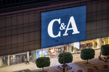 Warsaw, Poland - June 18, 2021: C&A store, clothing retail company in the city center at nightのeditorial素材