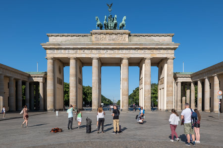 Berlin, Germany - July 31, 2021: Group of people, tourists at the Brandenburg Gate (Brandenburger Tor), city landmark, Neoclassical style architecture.のeditorial素材