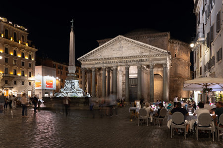Rome, Italy - September 6, 2020: Pantheon at night, ancient Roman temple at Piazza della Rotonda square with people at restaurant tables, fountain and ancient Egyptian obeliskのeditorial素材