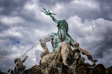 The Neptune Fountain against cloudy sky in Berlin, Germany. In Roman mythology god of the seas and fresh water, brother of Jupiter and Pluto. Statue from 1891, designed by Reinhold Begas.のeditorial素材