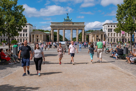 Berlin, Germany - August 8, 2021: People on the Pariser Platz with view to the Brandenburg Gate in...
