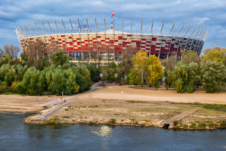 Warsaw, Poland - October 16, 2021: National Stadium (Polish: Stadion Narodowy, PGE Narodowy), football stadium in the capital city and beach at the Vistula Riverのeditorial素材