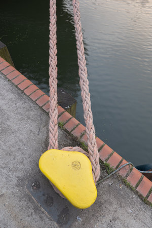 Mooring rope and bollard at sea port waterfront.の写真素材