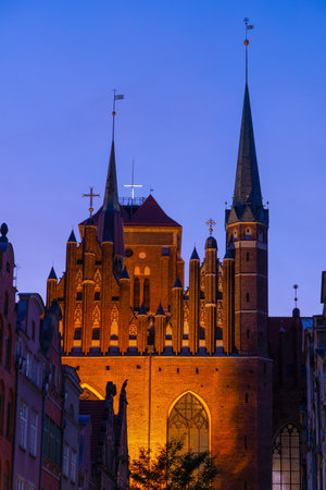 Late Gothic architecture of the St. Mary Basilica (Bazylika Mariacka) illuminated in the evening in city of Gdansk in Poland.の写真素材
