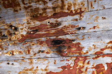 And old wooden boat weathered vintage background, aged planks of wood with peeling paint and nails.の写真素材