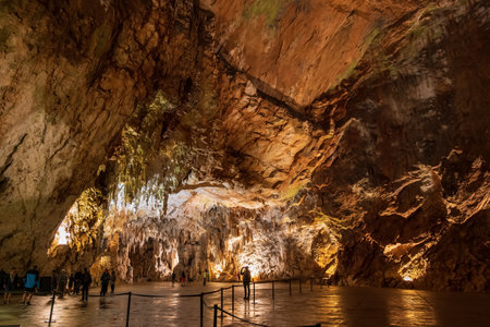 Postojna, Slovenia - July 15, 2022: The Postojna Cave (Slovene: Postojnska jama) amazing interior, large chamber near the exit, underground rock formations in karst cave system.のeditorial素材