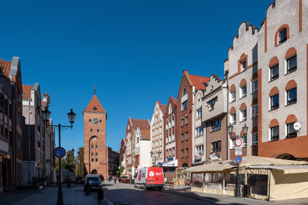 Elblag, Poland - October 10, 2022 - Old Market street in the Old Town with view to Market Gate tower.のeditorial素材
