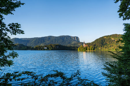 The Lake Bled scenery in the Julian Alps, Slovenia, tree branches making natural window frame, Upper Carniola region, northwestern Slovenia.の写真素材