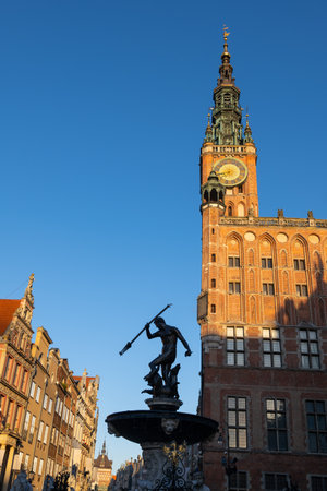 Poland, Gdansk, Old Town, Main Town Hall and Neptune Fountain at sunrise, city landmarks.の写真素材