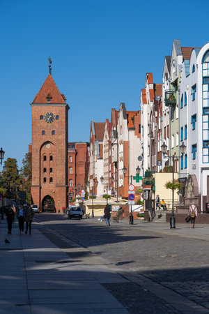 Elblag, Poland - October 10, 2022 - Old Market street in the Old Town with view to Market Gate tower, historic city center.のeditorial素材