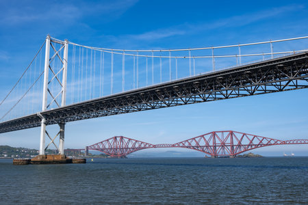 United Kingdom, Scotland, Forth Road Bridge and Forth Bridge across the Firth of Forth estuary.の写真素材