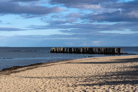 Sandy beach and pier remains at the Baltic Sea in Babie Doly, Gdynia, Poland.の写真素材