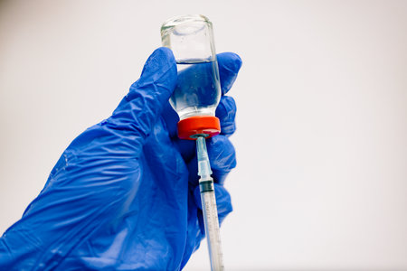 vaccine and vaccination concept 24 gauge syringe with red top vial.