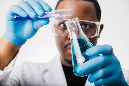 african american scientist in lab working with test tubes and beakersの写真素材