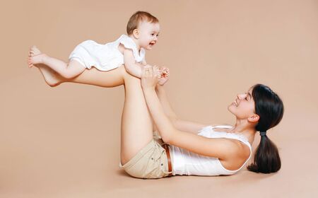 Mother holding baby, fun, exercise, leisure - conceptの写真素材