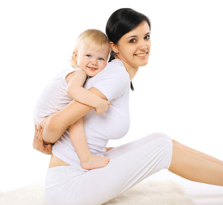 Portrait mom and baby doing exercise home, gymnastics, yoga, fitness and health - conceptの写真素材