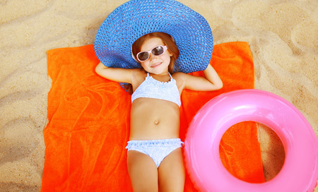 Summer vacation sea concept, relax girl lying on the sand with beach setの写真素材