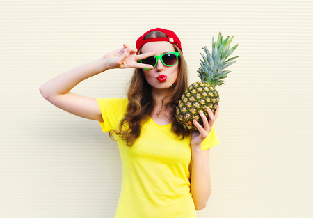Fashion pretty cool girl model with pineapple over white backgroundの写真素材