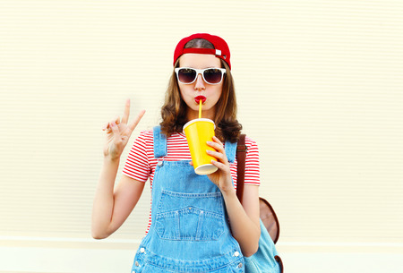 Fashion pretty cool woman with cup over white backgroundの写真素材