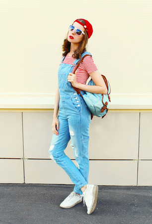 Fashion pretty woman model in denim jumpsuit over white backgroundの写真素材