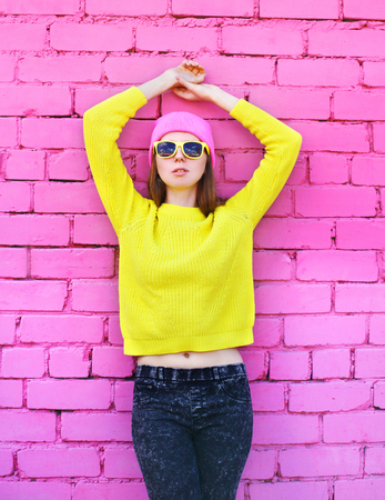 Fashion portrait pretty woman over colorful pink backgroundの写真素材