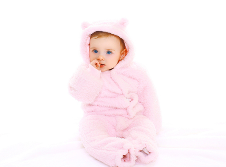 Portrait cute baby in pink bathrobe on white backgroundの写真素材