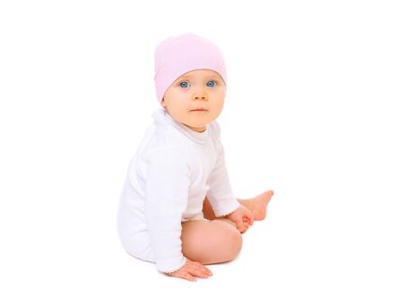 Portrait baby in hat sitting on a white backgroundの写真素材