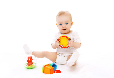 Cute little baby playing with toys on white backgroundの写真素材