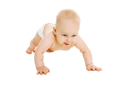 Cute little baby in diapers crawls on a white backgroundの写真素材