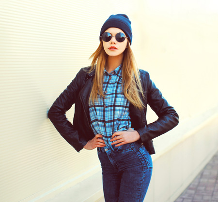 Fashion portrait pretty blonde woman posing in rock black style on a white backgroundの写真素材