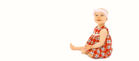 Portrait of cute little baby crawling and playing on floor on white backgroundの写真素材