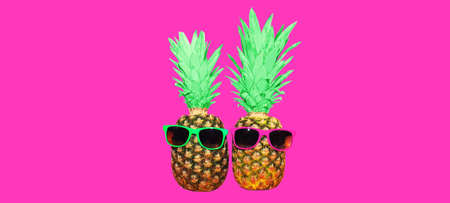 Pineapple with pink sunglasses on pink background, colorful ananasの写真素材