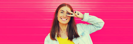 Summer portrait of happy cheerful smiling young woman in the city on colorful background