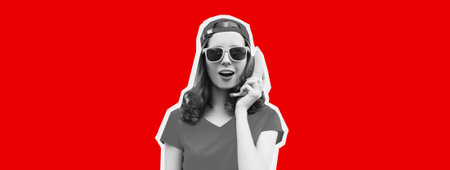 Portrait of funny young woman calling on a banana phone on red background, magazine styleの写真素材